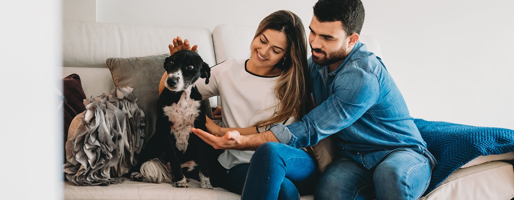 couple on couch with dog