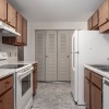 large kitchen with ample lighting and pantry in background